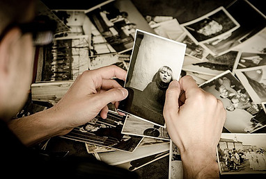 man looking at pictures- memory affected by lack of sleep